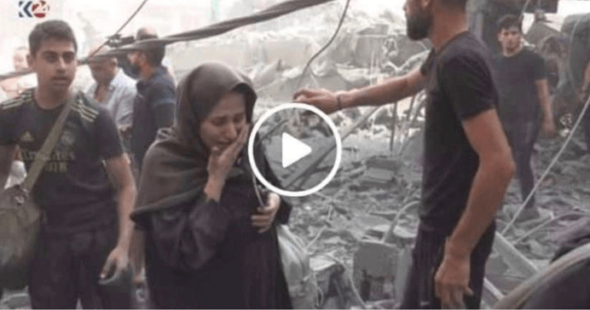 Still from a video of a news report showing Saja Redwan, heavily pregnant, evacuating from a destroyed building in Gaza.